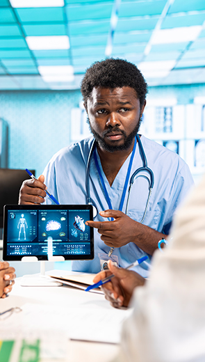 Surrey-based ultrasound specialist reviewing internal body scan with patient